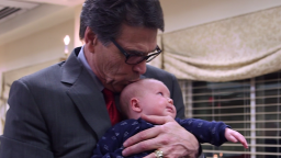 Rick Perry kisses a baby during a visit to New Hampshire on February 11.