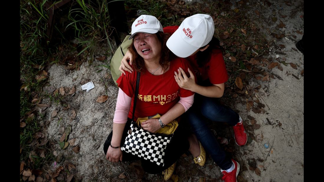 Relatives of the flight's passengers console each other outside the Malaysia Airlines office in Subang, Malaysia, on February 12, 2015. Protesters had demanded that the airline withdraw the statement that all 239 people aboard the plane were dead.