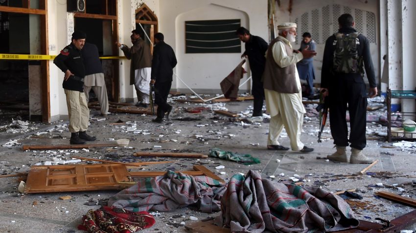 Pakistani security personnel inspect a Shiite Muslim mosque after an attack by Taliban militants in Peshawar on February 13, 2015. Grenade-toting Taliban militants stormed a Shiite mosque in northwest Pakistan, police said, in an attack that left at least 18 people dead.   AFP PHOTO / A MAJEED        (Photo credit should read A Majeed/AFP/Getty Images)