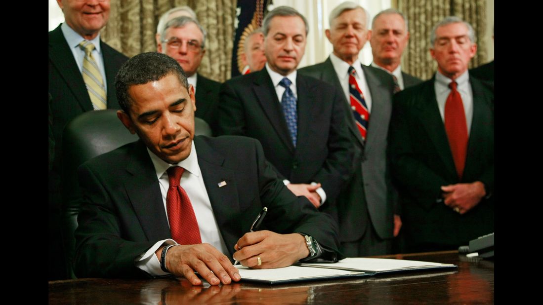 As retired military officers stand behind him, Obama signs an executive order to close down the detention center at Guantanamo Bay, Cuba, in January 2009.