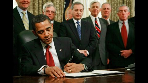 As retired military officers stand behind him, Obama signs an executive order to close down the detention center at Guantanamo Bay, Cuba, in January 2009.