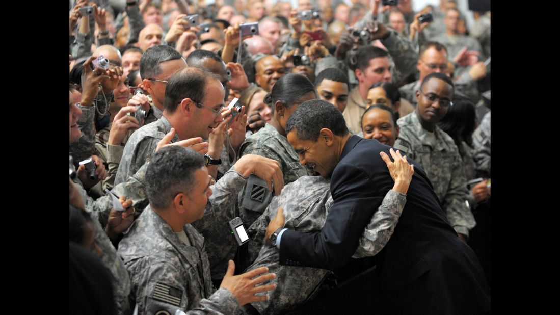 A soldier hugs Obama during his surprise visit to Camp Victory just outside Baghdad, Iraq, in April 2009. 