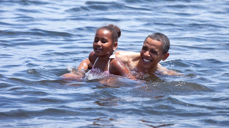 Obama and his daughter Sasha swim in Panama City Beach, Florida, in August 2010, to encourage people to come back to the Gulf Coast after a devastating oil spill.