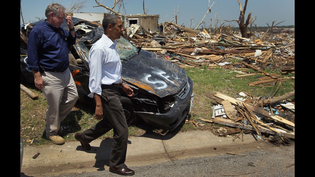 Obama and Missouri Gov. Jay Nixon walk together in May 2011 during a tour of the tornado devastation in Joplin, Missouri.