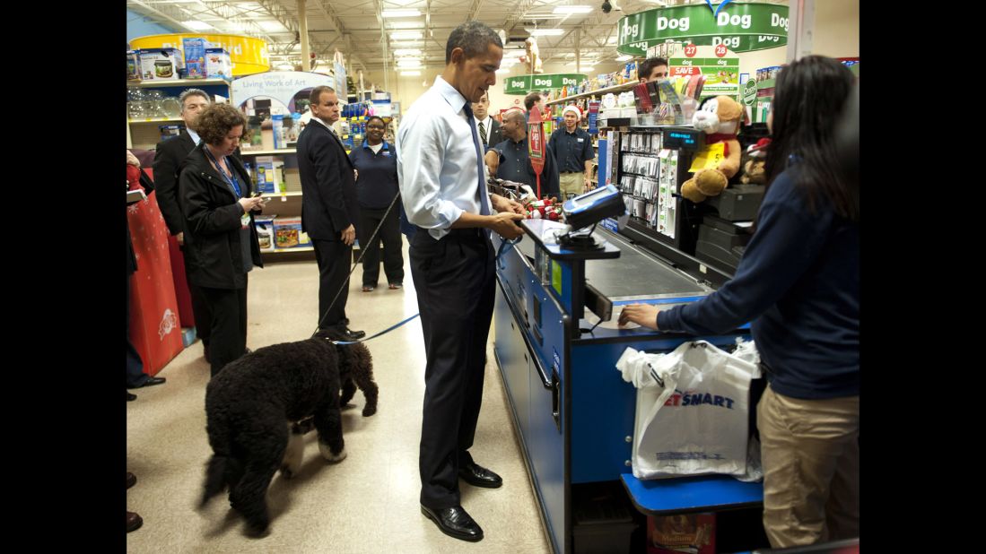 Obama pays for a dog toy as he shops with his dog Bo at a PetSmart in Alexandria, Virginia, in December 2011.
