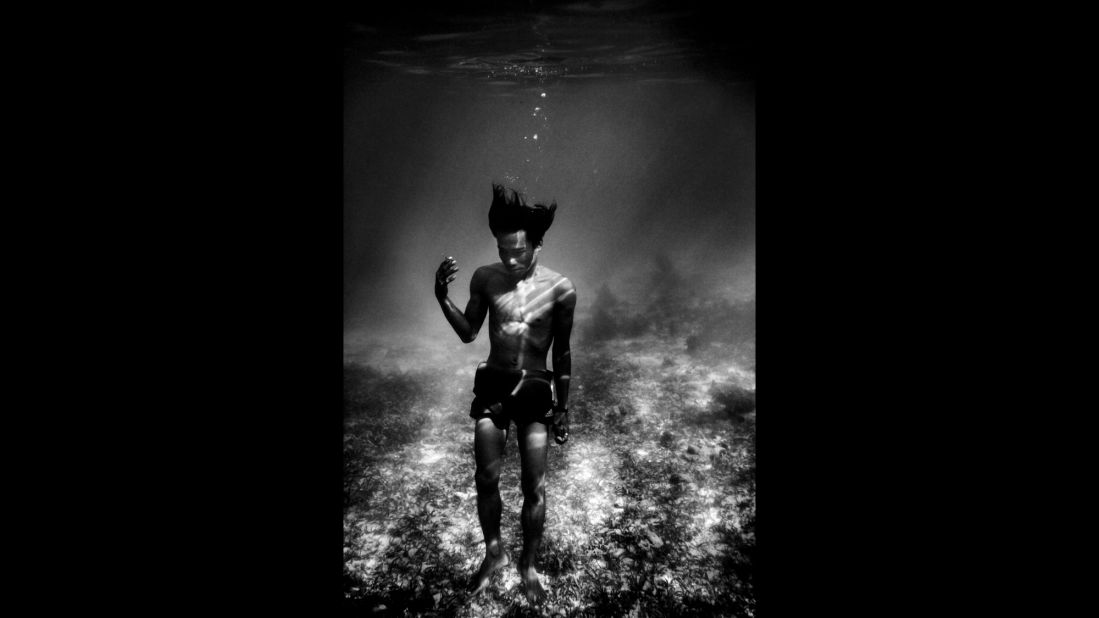 A Badjao man is photographed underwater in Mabul, a small island off the coast of Malaysia. The Badjao are a stateless people with no nationality in the traditional sense, residing instead in boats and living off the sea.