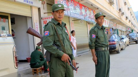 Ethnic Kokang soldiers stand guard in the Myanmar-China border town of Laukkai in 2009. 