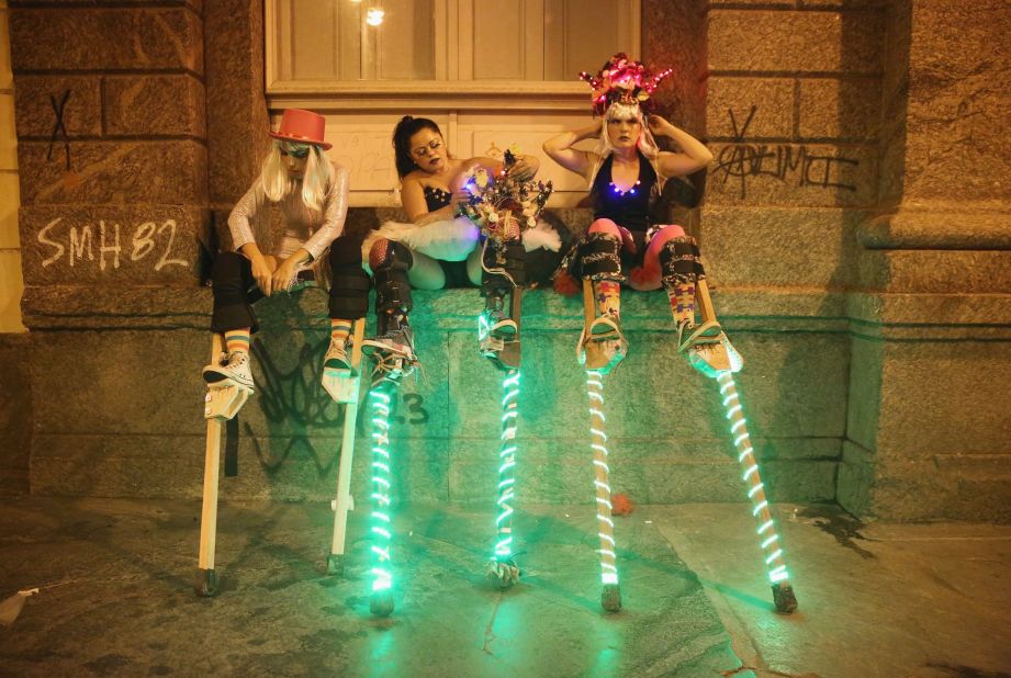 Stilt walkers prepare to perform in Rio de Janeiro on Thursday, February 12.