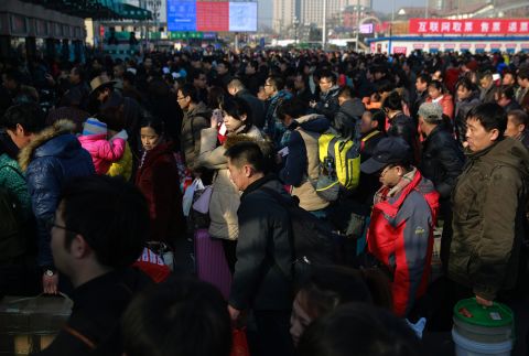 Chinese travelers queue up at the main entrance of the Beijing railway station in Beijing on Friday, February 13. Millions of Chinese were to travel to their hometowns to celebrate the Lunar New Year on February 19, marking the Year of the Sheep.