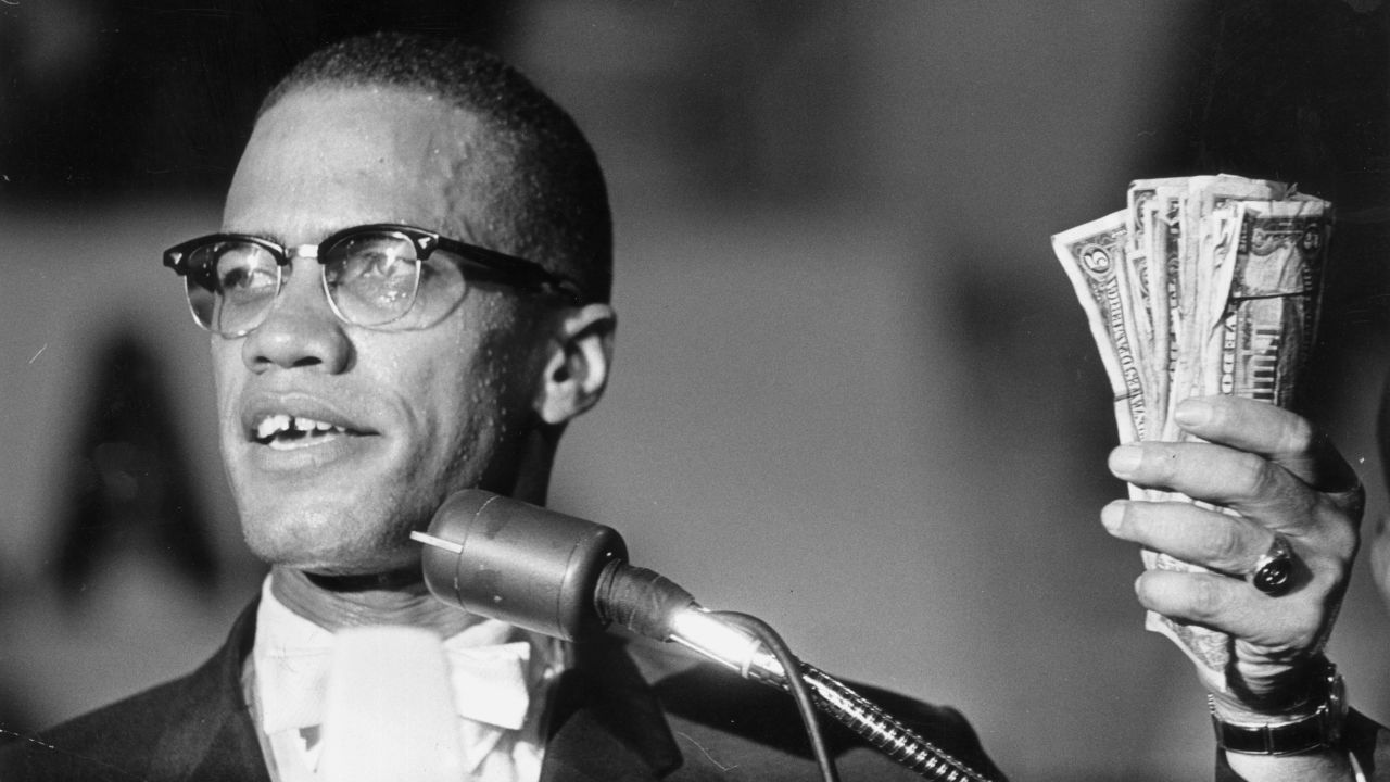 Malcolm X holds cash during a speech in Washington in 1963.