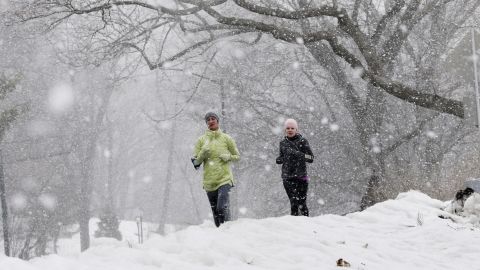 Joggers run in the snow, Thursday, February, 12, in New York's Central Park.