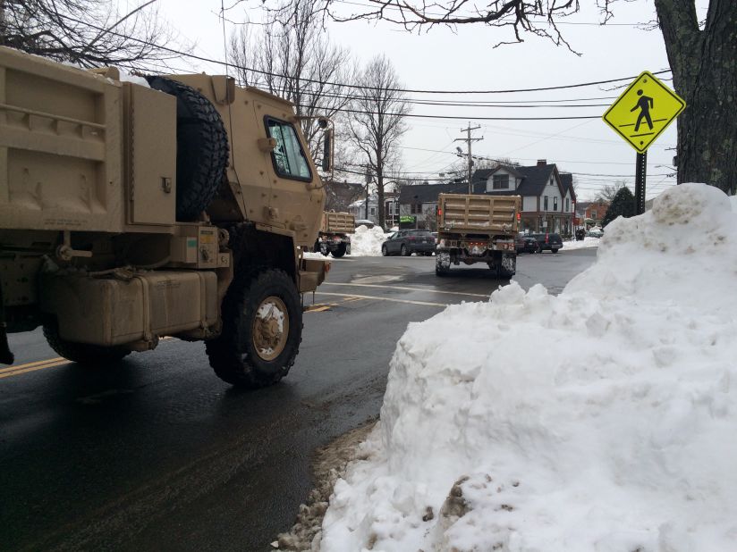 Trucks from the U.S. Army National Guard roll into Rockport, Massachusetts, on Saturday, February 14, ahead of the predicted blizzard to assist with snow removal.