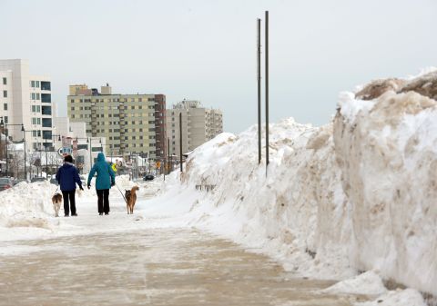 Women walk their dogs along Revere Beach on February 14 in Revere, Massachusetts. 