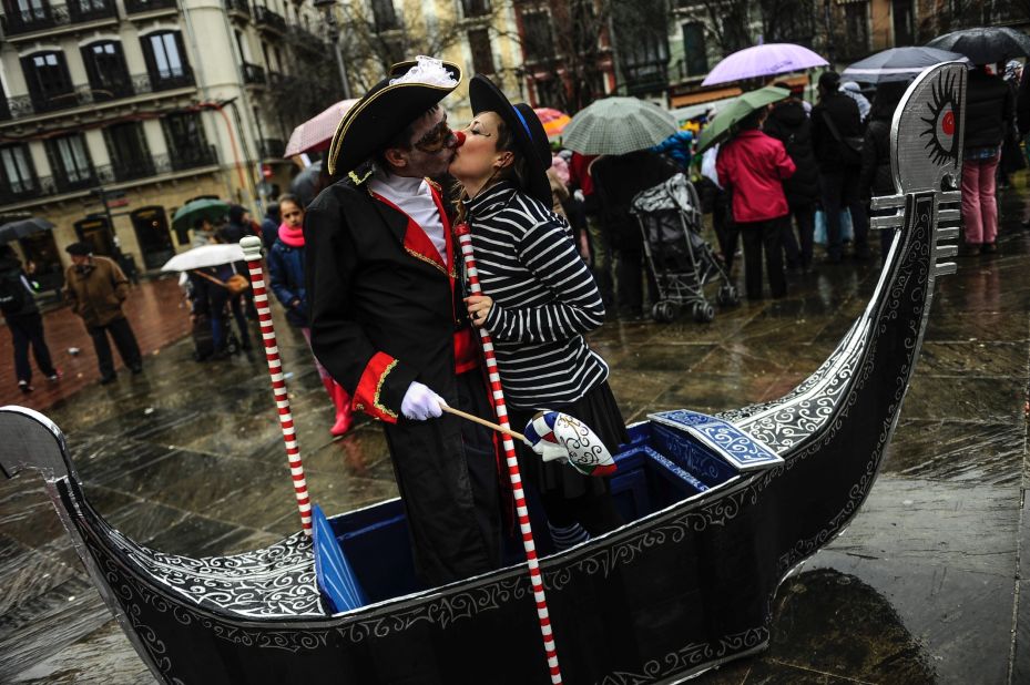 A couple dressed in Venetian costumes kiss in Pamplona, Spain, on February 14.