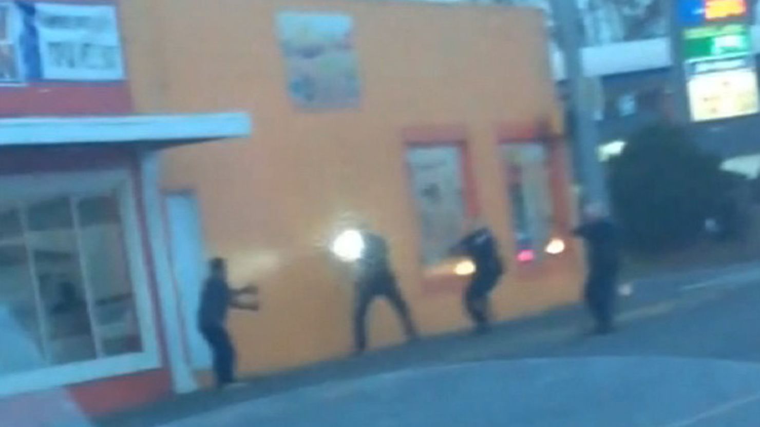 In an frame taken from a YouTube video posted by Dario Zuniga, Antonio Zambrano-Montes, 35, (far left) is seen immediately before he was fatally shot by Pasco, Washington, police officers who confronted him (three, to the right).  The officer closest to him is holding a flashlight.