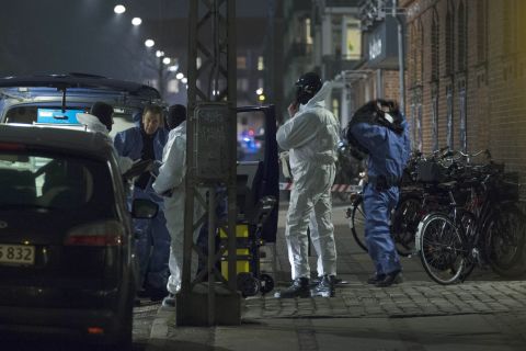 Forensic officers confer near the scene of a shooting Saturday, February 14, in Copenhagen, Denmark. 