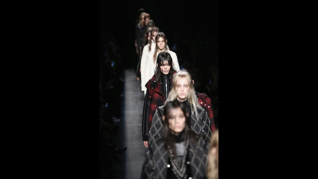Taking a break from the season's 1970s theme, models stomp down the runway in heavy-metal hair and makeup for Alexander Wang's edgy fall collection.