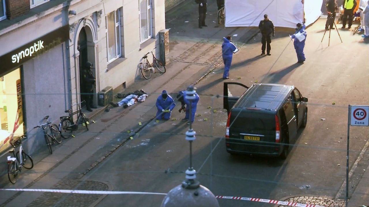 The body of a shooting suspect lies on the pavement, left, as Danish forensic officers examine the scene after police shot and killed the man early on February 15. 