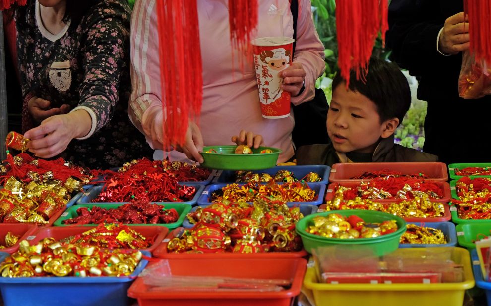 A boy picks a lucky amulet on February 14 at a traditional flower market in Taipei, Taiwan, where Taiwanese shop for their home decorations to welcome the upcoming Lunar New Year.