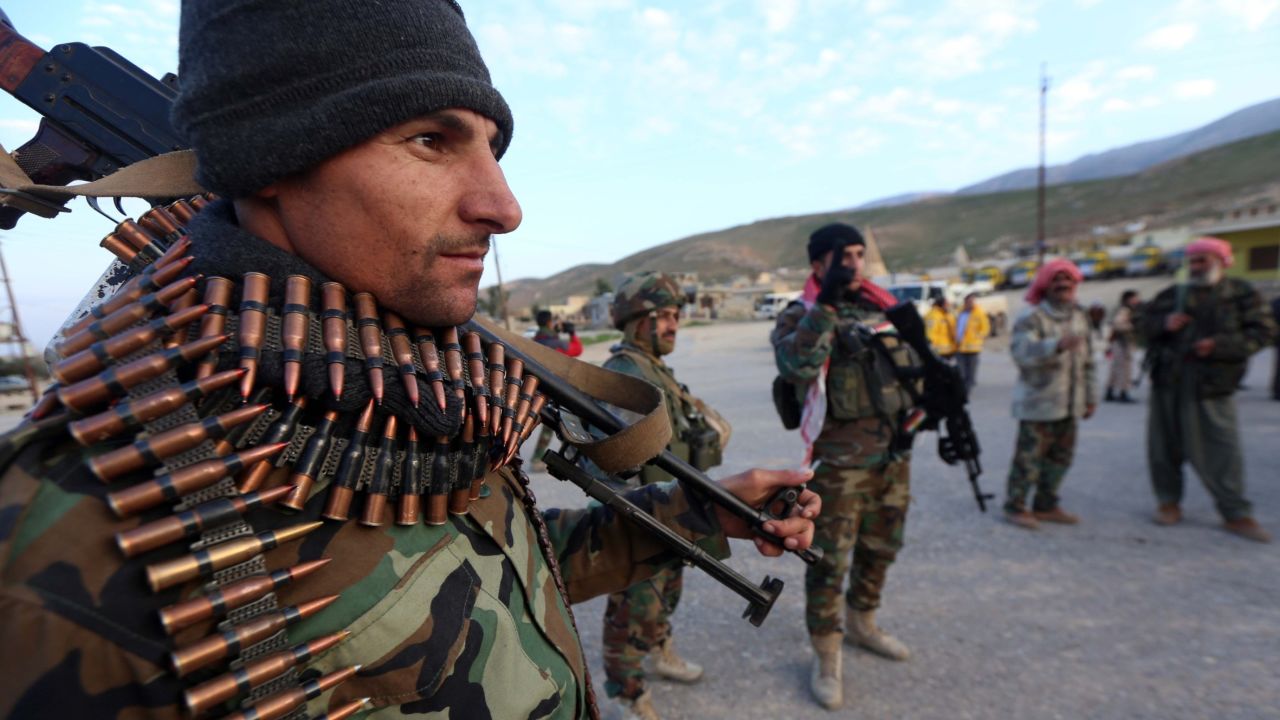 Fighters of Kurdish Peshmerga forces get ready for an operation on December 20, 2014 at Mount Sinjar, west of Mosul, northern Iraq.