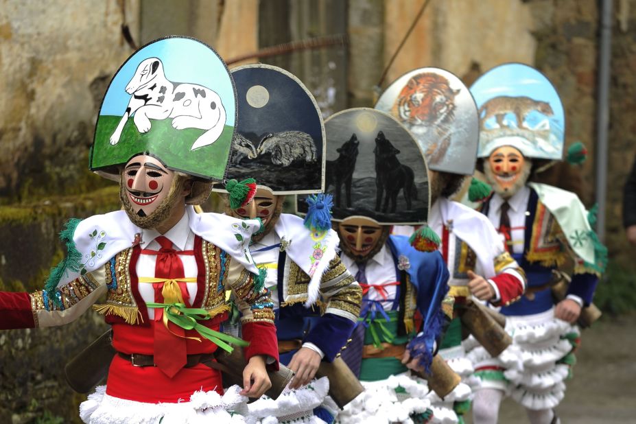 People dressed in intricate "Peliquiero" garb run during the Entroido festival February 15 in Laza, Spain. Peliqueiros, the event's main characters, lash out at onlookers with flour, water and live ants as ammunition.