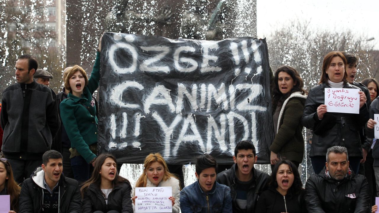 Protesters hold a banner reading 'Ozge, we have suffered with you' during a demonstration in Ankara.