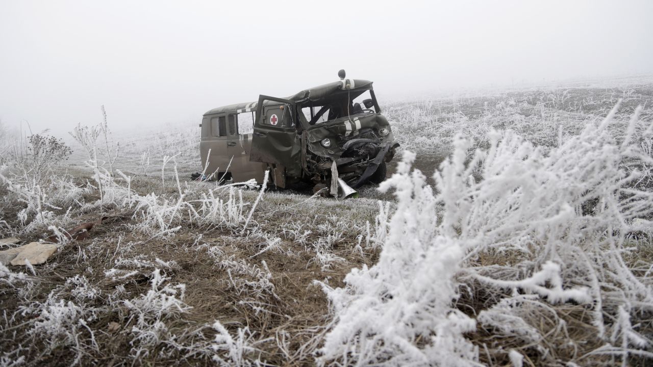 An army ambulance damaged in recent shelling lies by a road near Svitlodarsk, Ukraine, on Sunday, February 15.