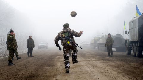 Ukrainian servicemen play with a soccer ball on a road between Svitlodarsk and Debaltseve on February 15.