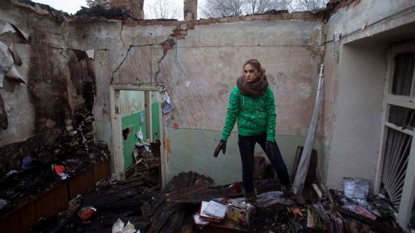 A woman salvages items from the rubble of a destroyed clinic where she had worked in Opytne, Ukraine, on February 15.