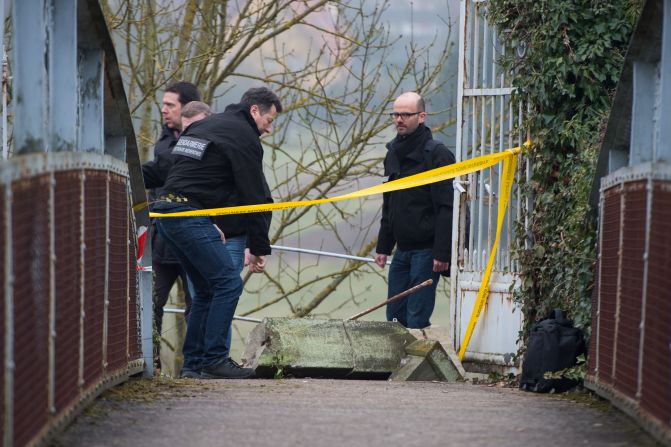 Police on Monday, February 16, inspect the scene where hundreds of Jewish graves were defaced at a cemetery in Sarre-Union, France.