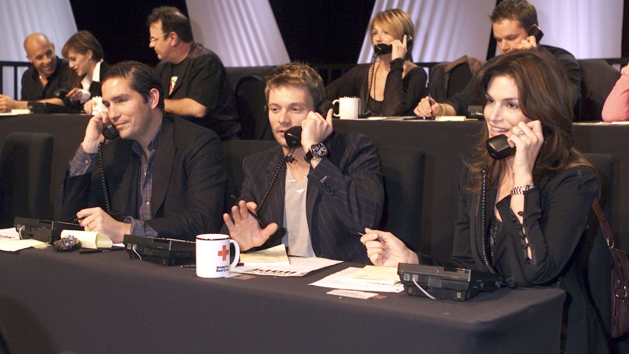Jim Caviezel, left, Ryan Seacrest and Crawford take calls during the "Tsunami Aid: A Concert of Hope" telethon in 2005.