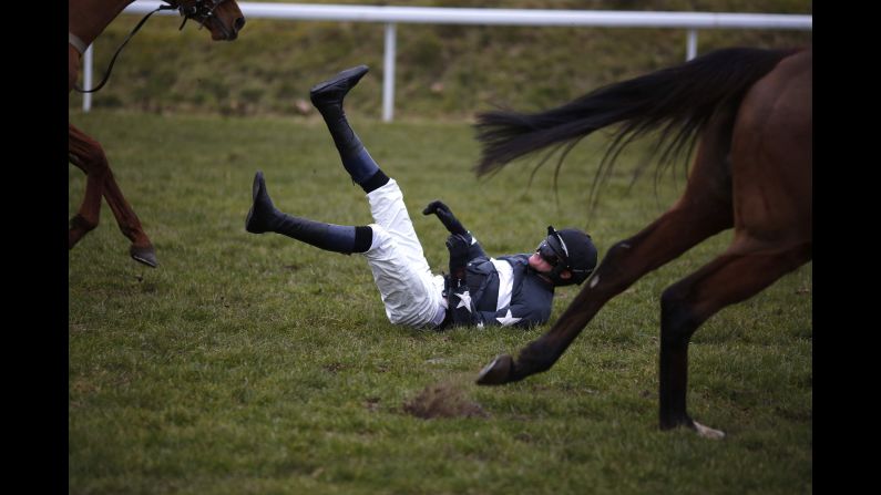 Jockey Conor Ring falls off his horse Wednesday, February 11, at Chepstow Racecourse in Chepstow, Wales.