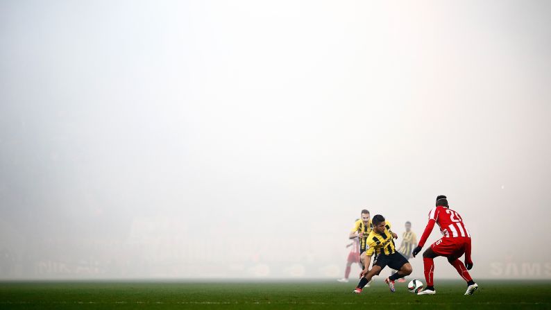 Vangelis Platellas of AEK Athens tries to dribble past Arthur Masuaku of Olympiakos during a Greek Cup match in Athens on Wednesday, February 11. The match ended 1-1.