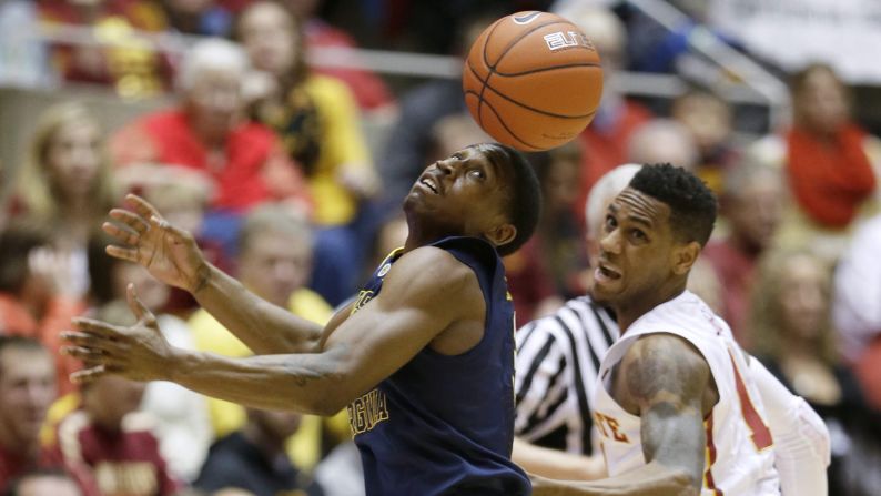 West Virginia guard Juwan Staten, left, loses control of the ball during a college basketball game in Ames, Iowa, on Saturday, February 14.