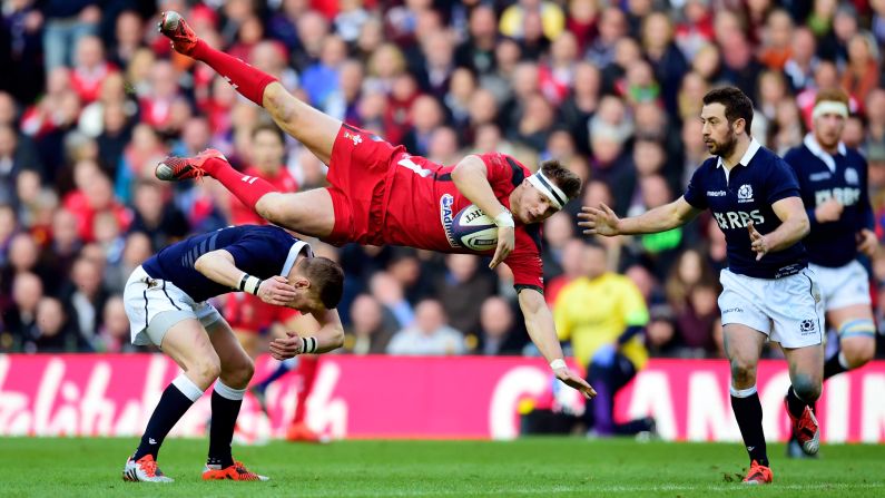 Welsh rugby player Dan Biggar falls over Scotland's Finn Russell during a Six Nations match in Edinburgh, Scotland, on Sunday, February 15. Wales won the match 26-23.