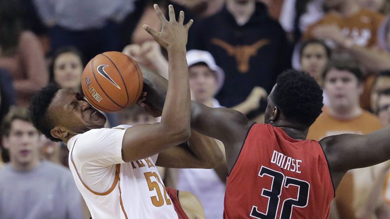 Texas' Myles Turner is hit in the face with the ball as he and Texas Tech's Norense Odiase scramble for a rebound Saturday, February 14, in Austin, Texas.