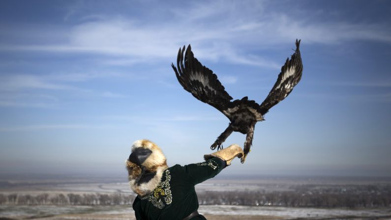 A hunter releases his tamed golden eagle during an annual hunting competition outside Almaty, Kazakhstan, on Saturday, February 14.