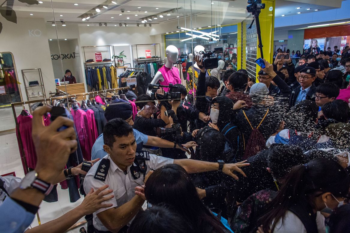 Police make arrests and use pepper spray against protesters in Hong Kong on February 15, as dozens of local residents rally against mainland Chinese shoppers in a popular shopping mall.