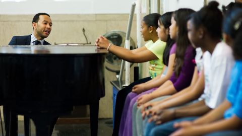 John Legend playing music with students 