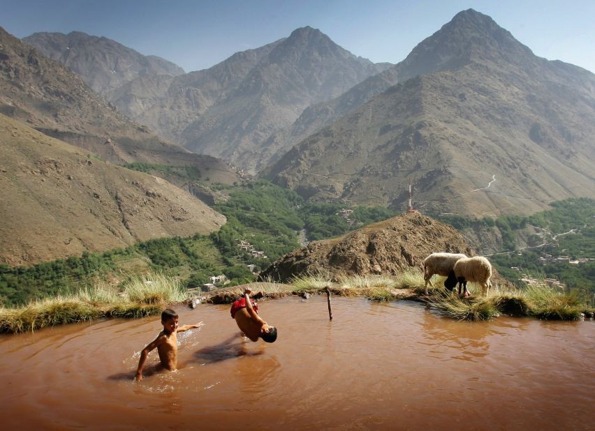 Berber children swim in an irrigation pool on the side of a mountain in the village of Ait Souka near the Imlil district in Morocco. The irrigation pool gradually fills up during the day then is drained in the evening to supply crops and the village. 