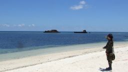 In this photograph taken in June 2014 a military personnel stands on the beach at Thitu island (Pag-asa) which hosts a small Filipino town as well as an airstrip used for civilian and military flights in the disputed Spratly islands in the South China sea. The Philippines said June 19, 2014 it would ask a UN tribunal to speed up its appeal to declare China's expansive claims to the South China Sea invalid. President Benigno Aquino's spokesman Herminio Coloma also confirmed that the Philippines would repair an airstrip on Thitu island, one of the disputed Spratly islands occupied by Philippine troops in the South China Sea. AFP PHOTO (Photo credit should read STR/AFP/Getty Images)