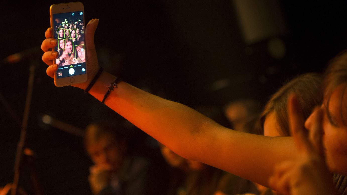 Fans in the front row of a George Ezra concert snap a selfie Friday, February 13, in Barcelona, Spain.