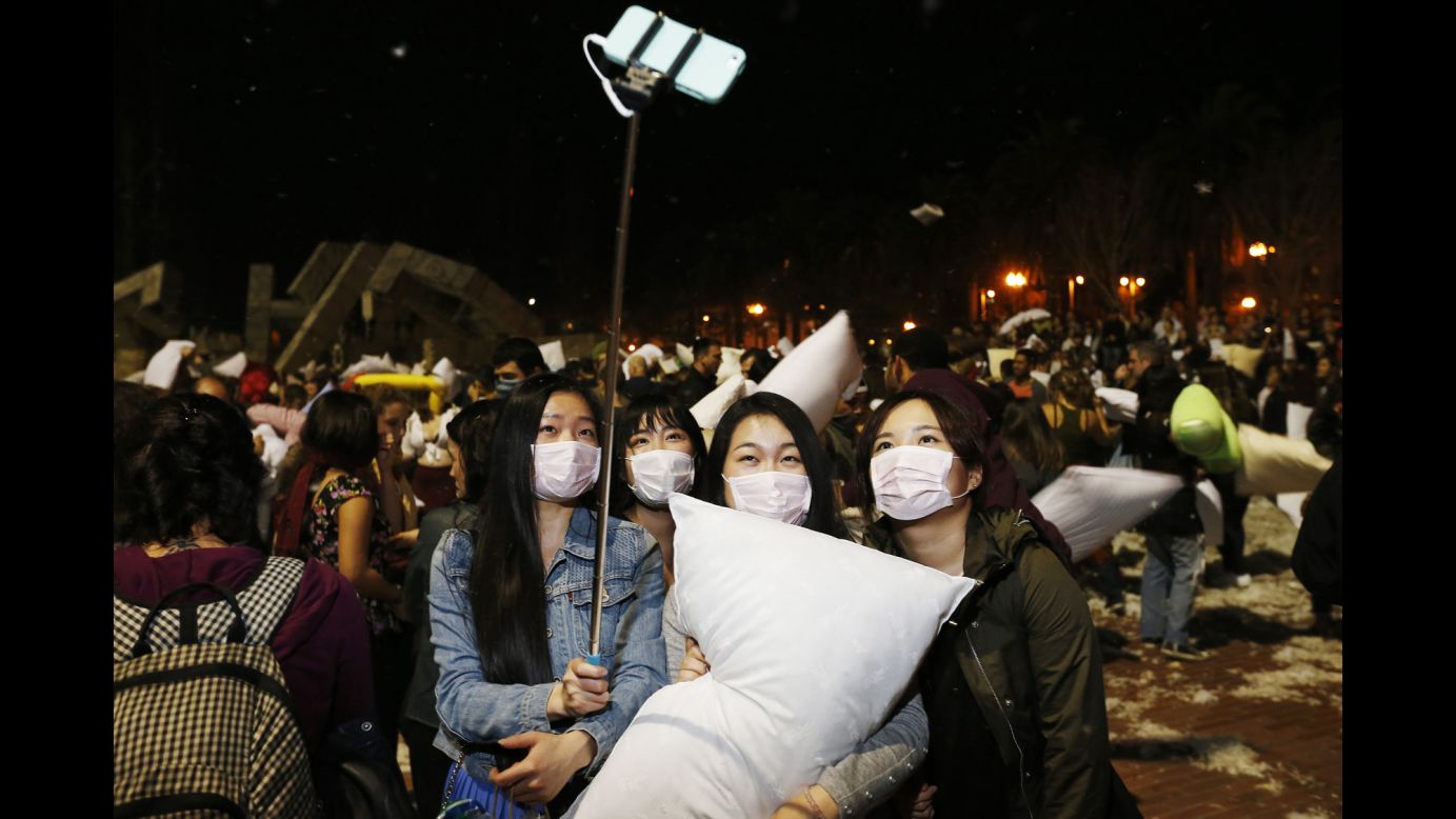 People take a selfie during the Great San Francisco Pillow Fight, an annual Valentine's Day tradition. Participants are encouraged to wear masks so they don't inhale feathers.