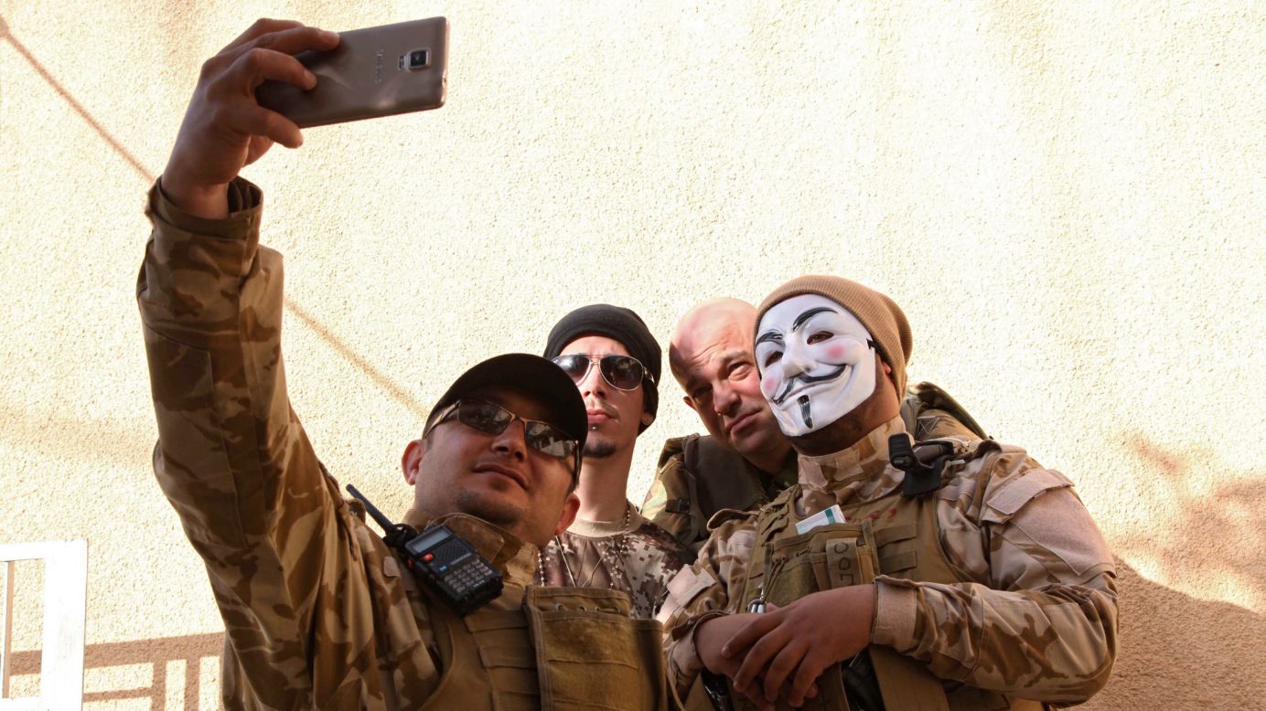 Westerners who have joined the Iraqi Christian militia Dwekh Nawsha to fight the ISIS militant group take a photo together in Dohuk, Iraq, on Friday, February 13.
