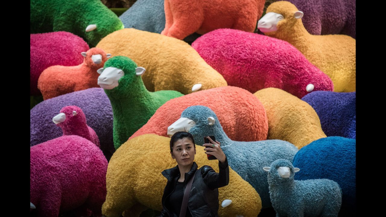 A woman takes a selfie in front of an art installation set up for Lunar New Year celebrations in a Hong Kong shopping mall on February 18.