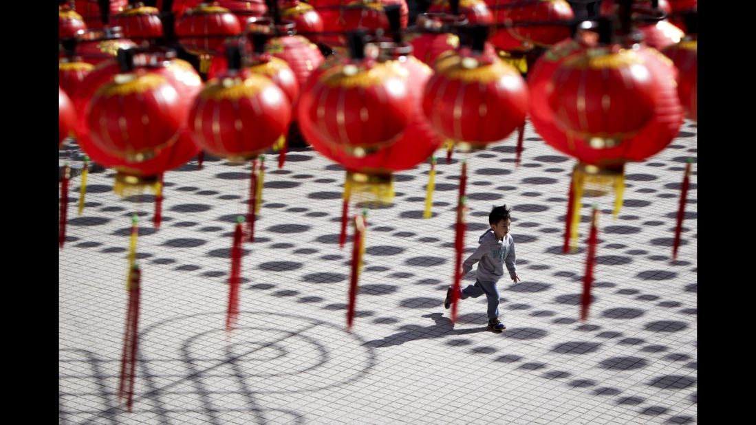 A boy runs through a temple with Chinese lantern decorations in Kuala Lumpur, Malaysia, on Tuesday, February 17.