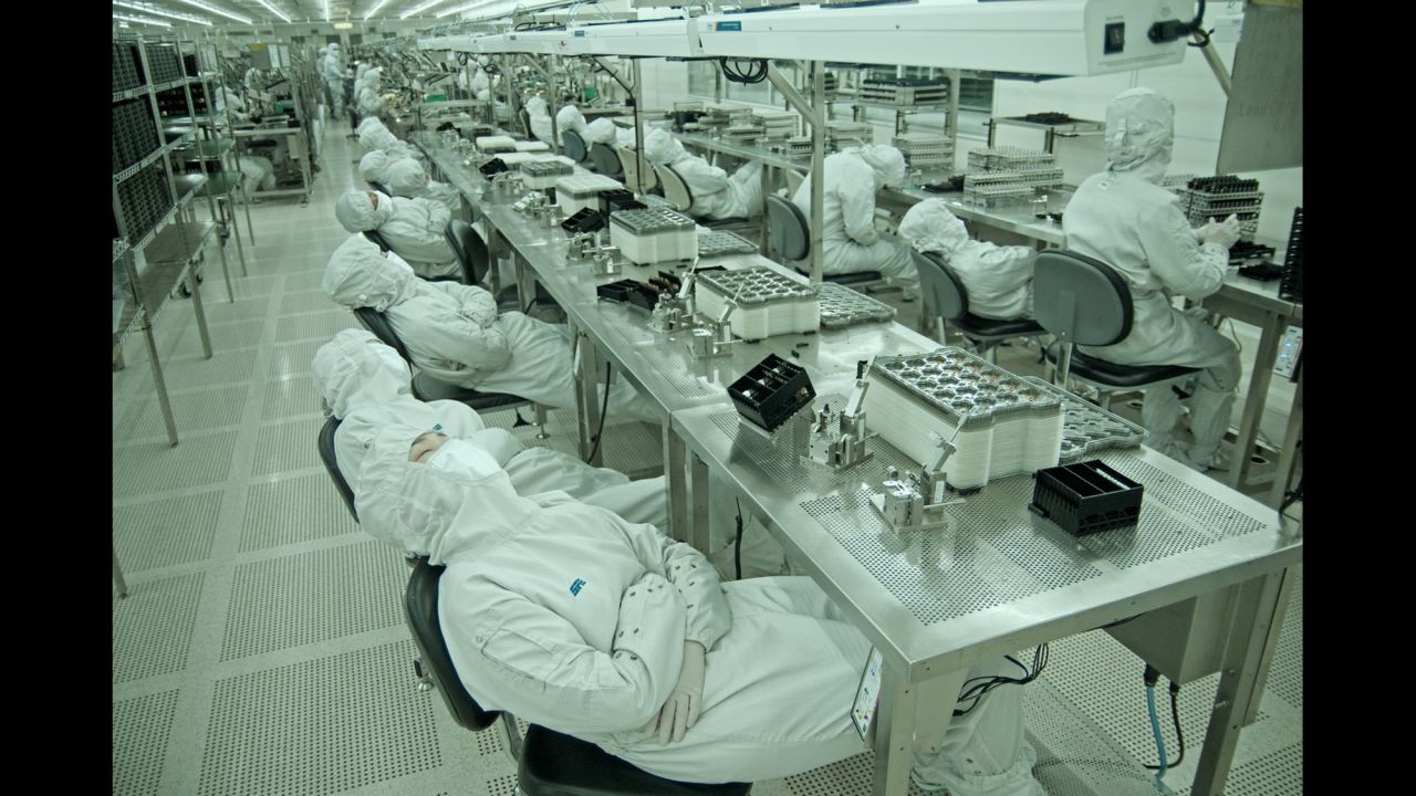 Workers take a nap on the assembly line.  They can take a 10-minute break each day. 