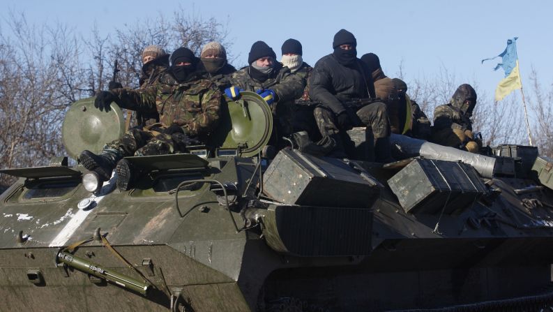 Ukrainian servicemen ride on top of an armored personnel carrier on the way from Artemivsk to Debaltseve.
