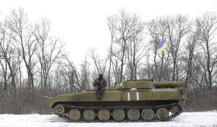 A Ukrainian soldier rests on his vehicle near the road between the towns of Debaltseve and Artemivsk on February 16.