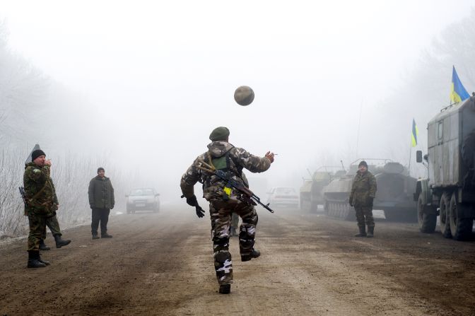 Ukrainian servicemen play football on a road in Svitlodarsk approaching Debaltseve on February 15. <a href="index.php?page=&url=http%3A%2F%2Fcnn.com%2F2015%2F02%2F15%2Feurope%2Fukraine-conflict%2F">The ceasefire went into effect after midnight,</a> followed by brief accusations of violence.